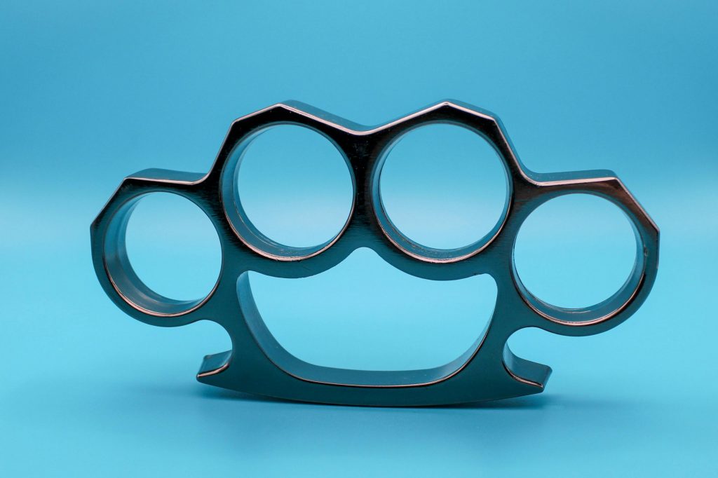 A person facing charges for possession of brass knuckles under California Penal Code 21810 PC.